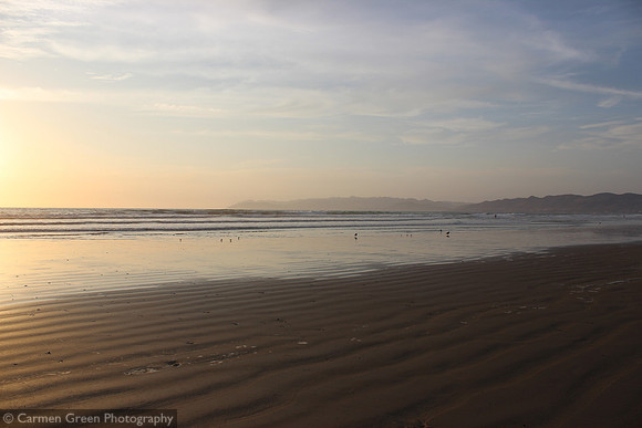 Sunset and waders at Pismo Beach California